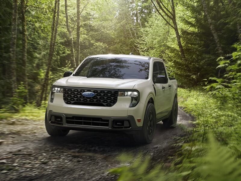 Ford Maverick driving through woods with motion blur from Ford Dealer near Marysville OH